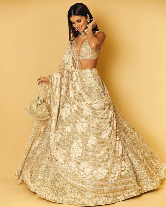 image of Tara Sutaria's white and gold lehenga for wedding
